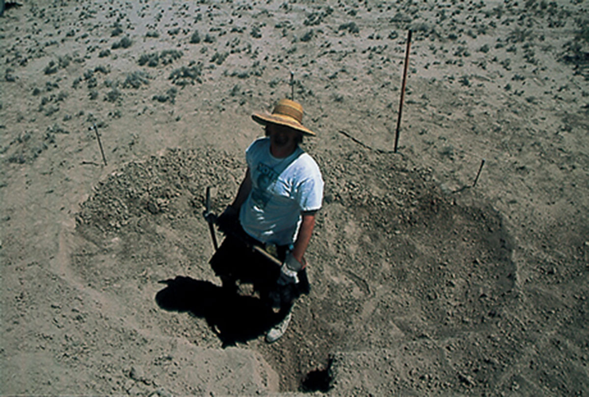 A photograph of a Matthew Passmore standing on the foundations of the Cabinet National Library.