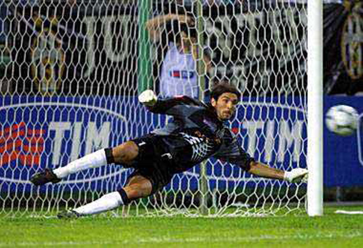 A photograph of Buffon saving a goal.