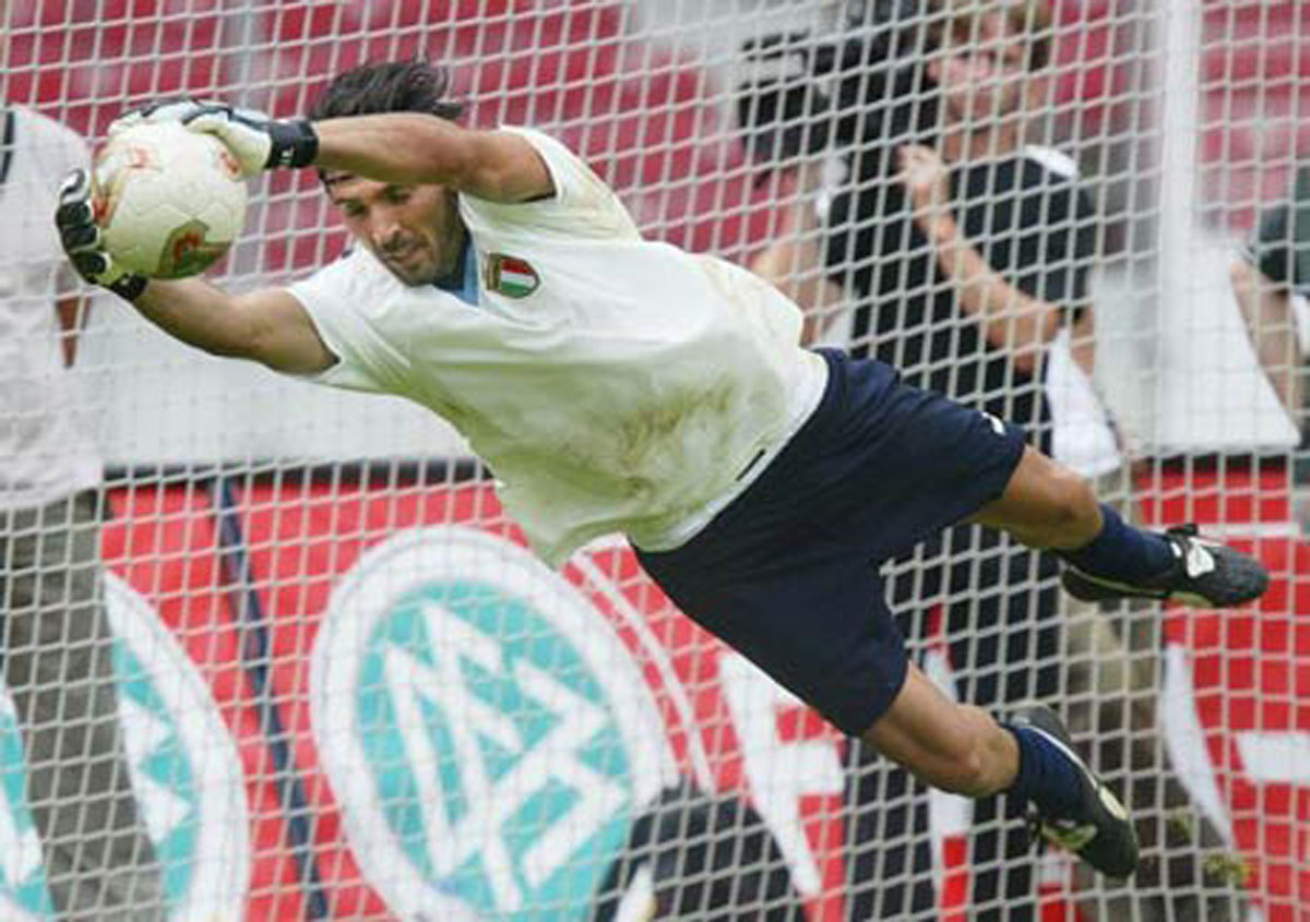 A photograph of Buffon saving a goal.