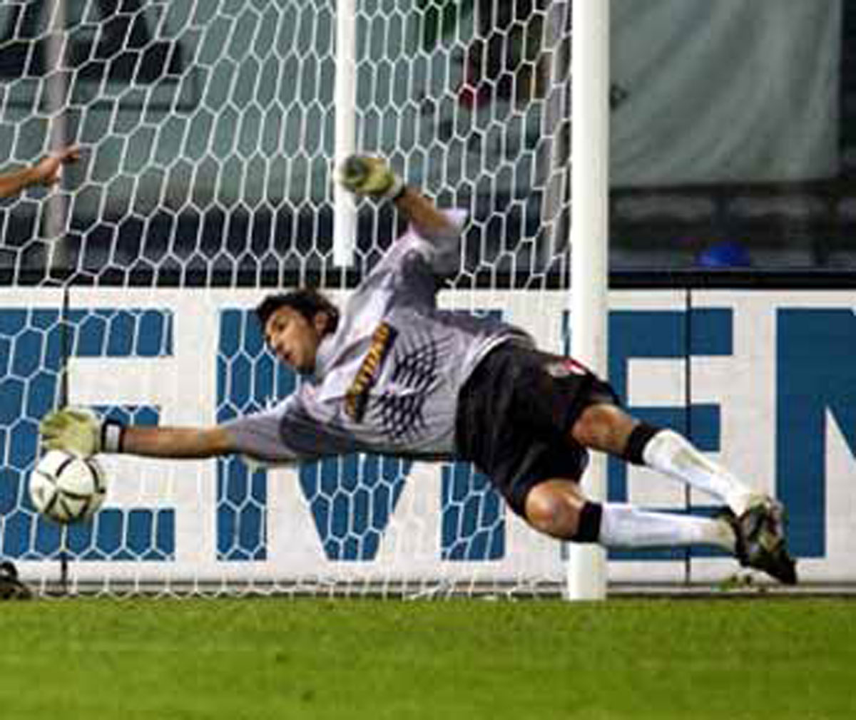 A photograph of Buffon saving a goal.