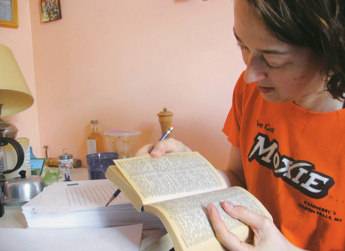 A photograph of Molly Powell at work editing a text.