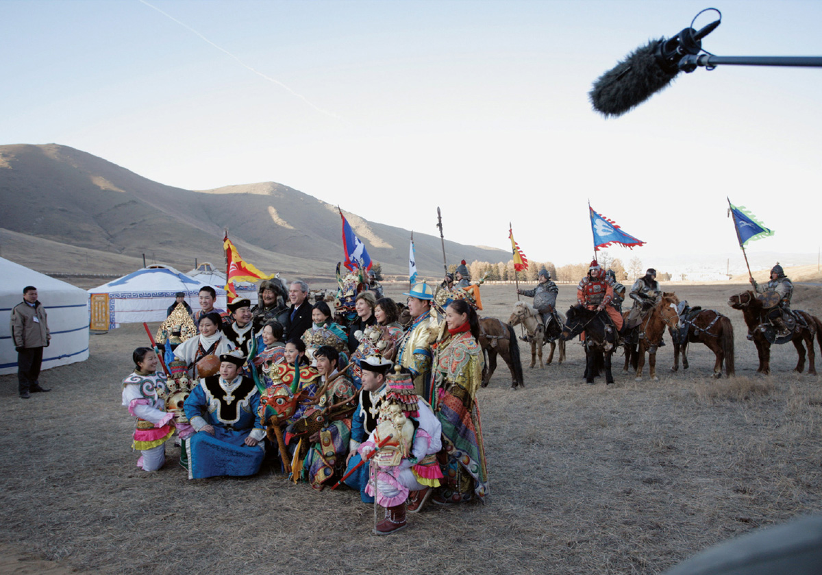 George W. Bush and Laura Bush standing with traditionally dressed men and women in Mongolia.