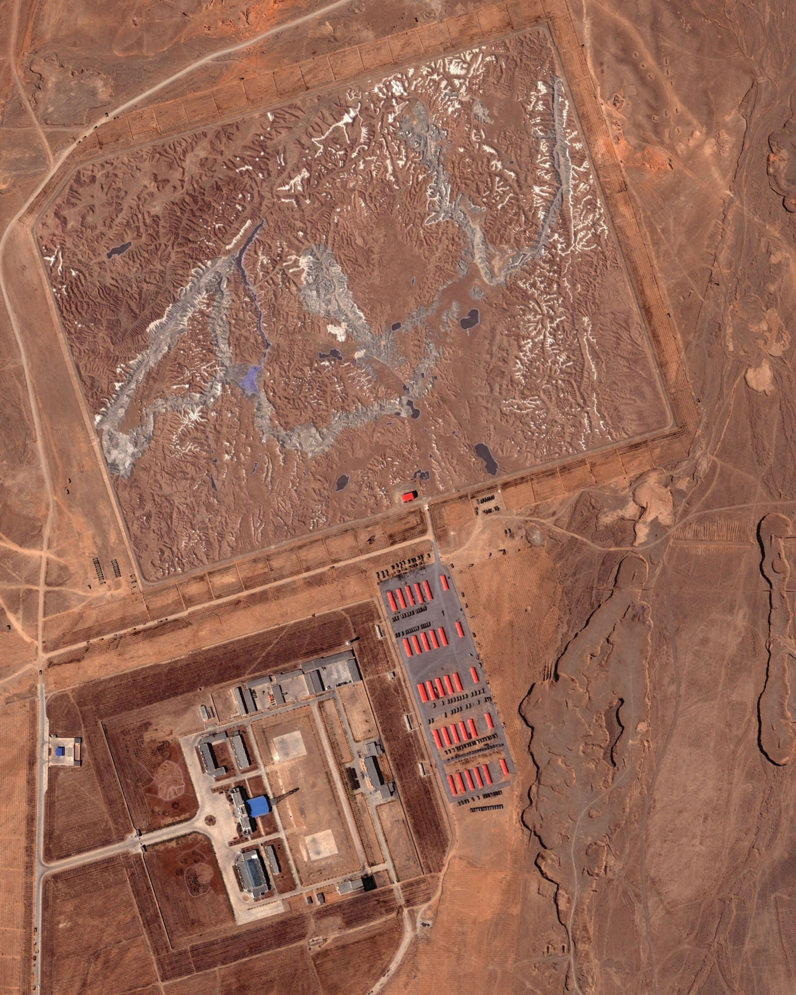 A atellite image of a man-made mountain range located at a military complex in China’s arid Huangyangtan province. Outfitted with artificial lakes and snow-capped peaks, the range appears to be a terrain model of Aksai Chin, an area on the border of India and China claimed by both countries. The facility was discovered in June two thousand and six by a Google Earth user based in Germany.