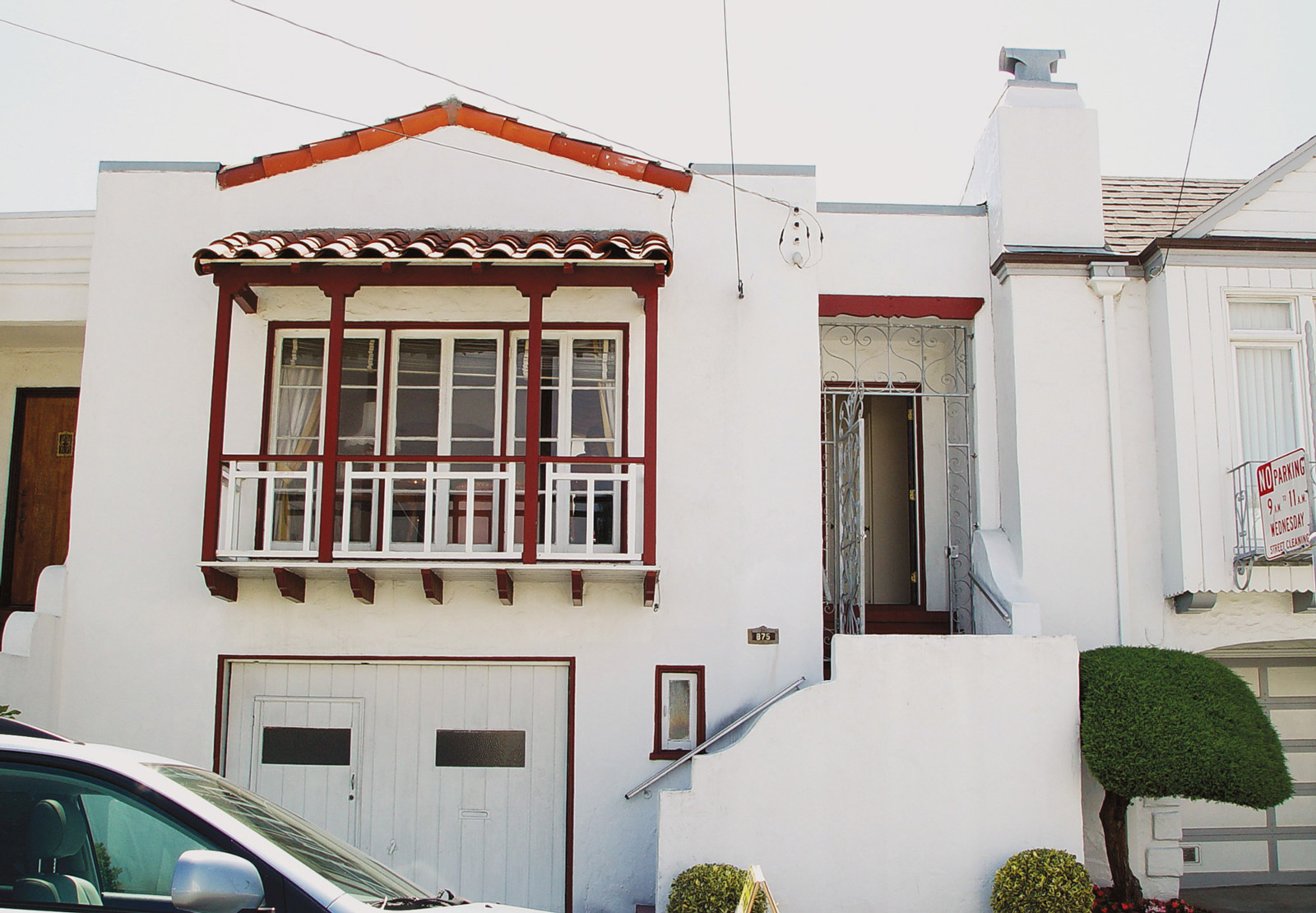 A photograph titled “House of Sin” depicting the facade of a house, from Casey Logan’s two thousand and seven artist project titled “Shopping in Sin.”