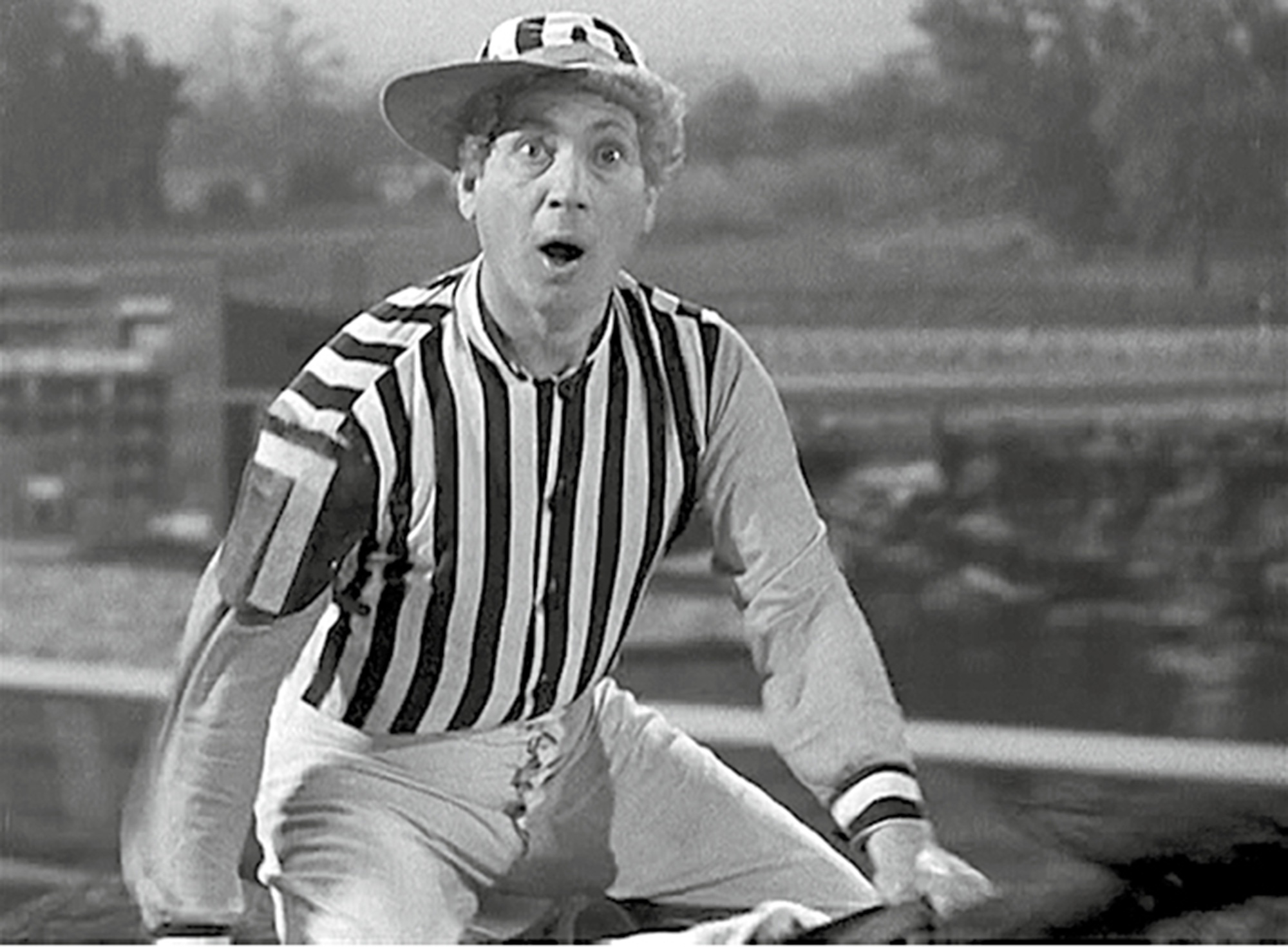 A still from the nineteen thirty-seven film “A Day at the Races” depicting Harpo Marx as a jockey in a horse race.