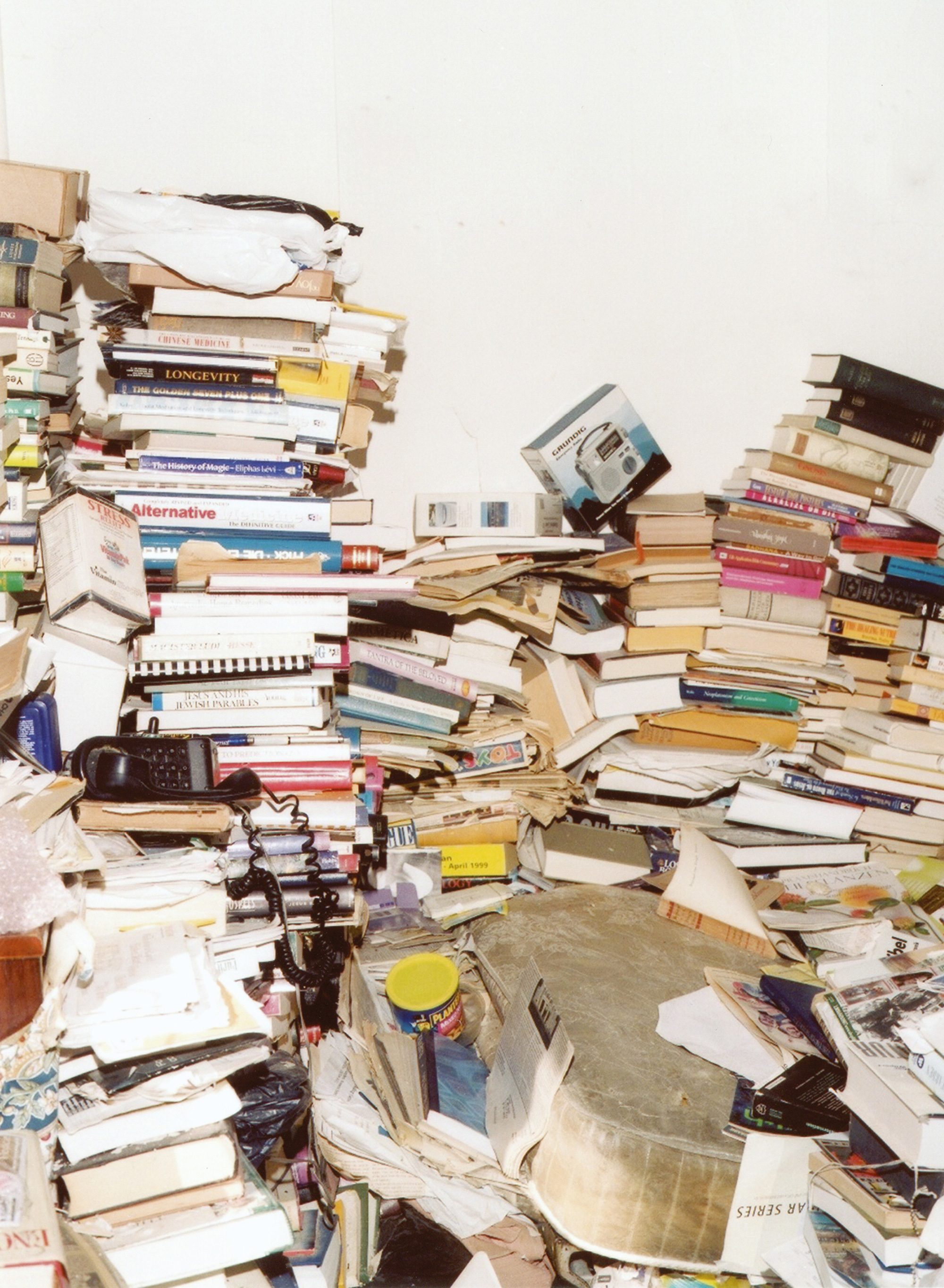 A photograph by Michael Schmelling of a disposophobic’s disorderly home. The photograph is featured in Schmelling’s book “The Plan.”