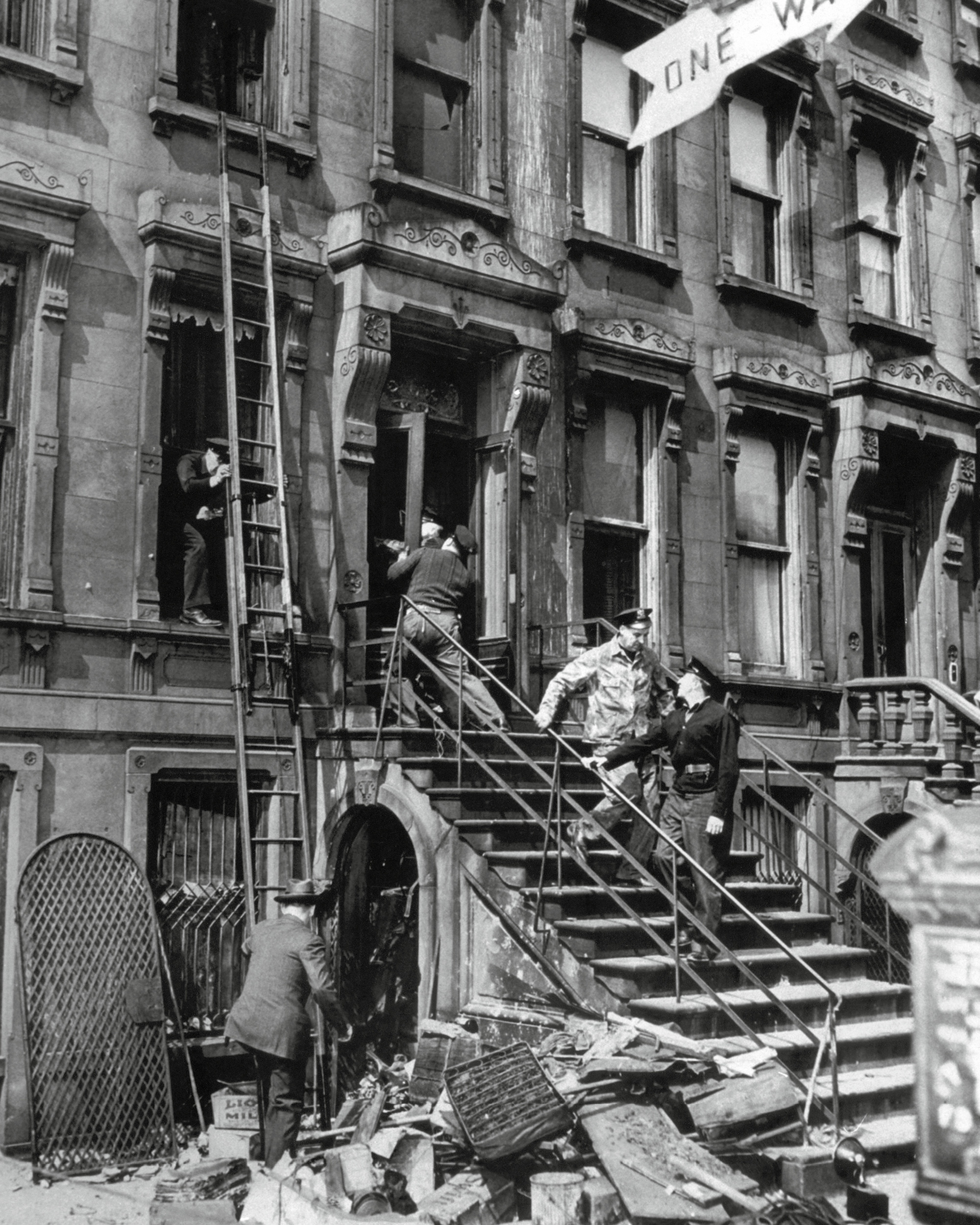 A photograph of police entering Collyer mansion in March 1947 after receiving a report of a dead body on the premises.