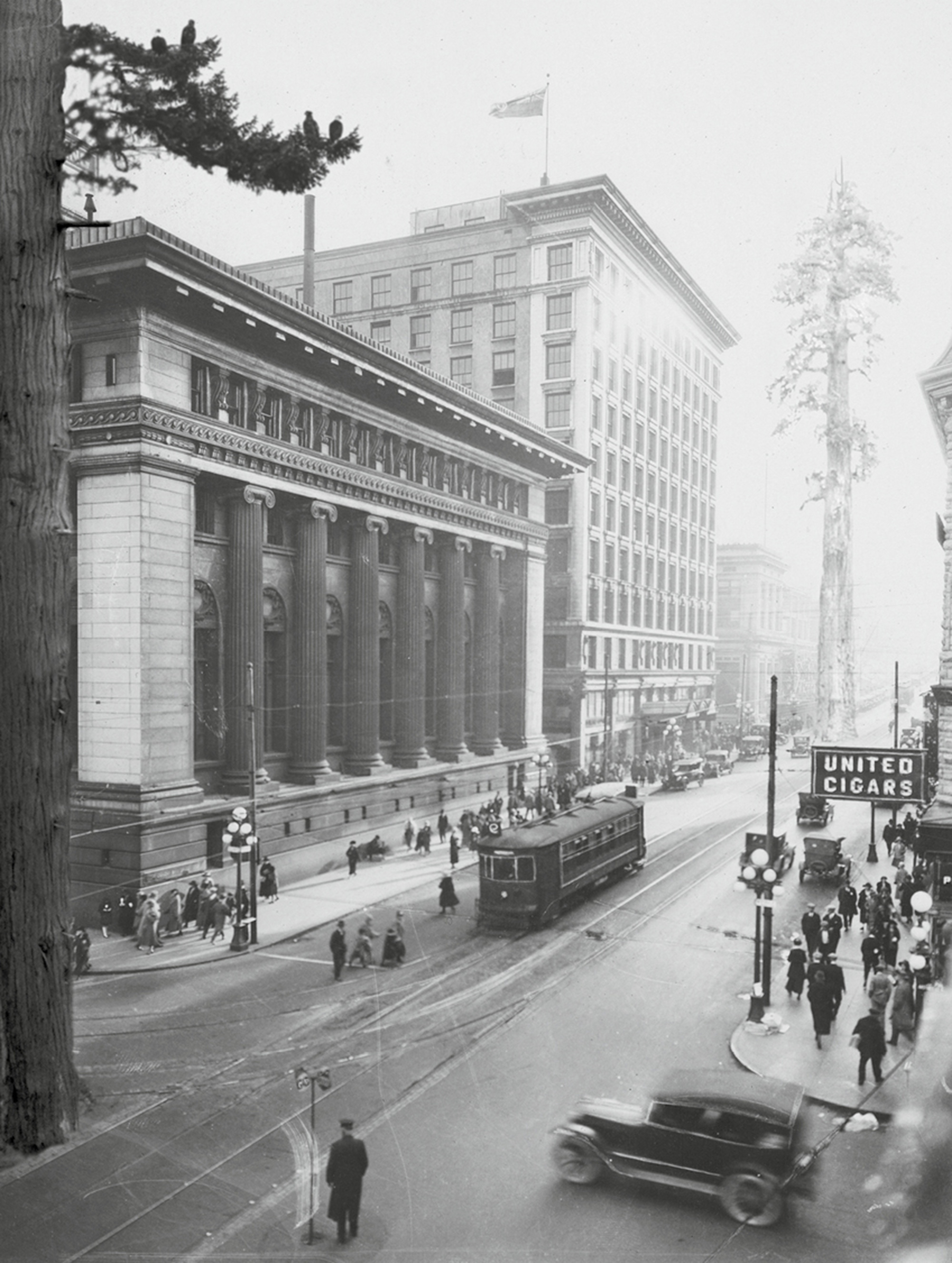 A photograph titled “Roundabout Vancouver: Hastings Street circa nineteen twenties.” It shows a busy downtown area.