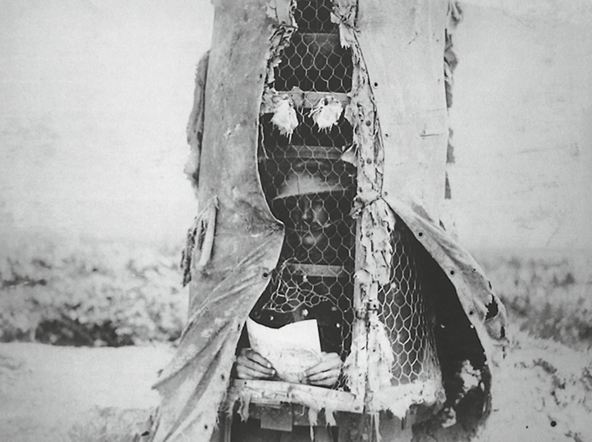 A nineteen eighteen photograph of a canvas-and-steel observation post near Souchez, France. This back view shows the limited interior space available for observers.