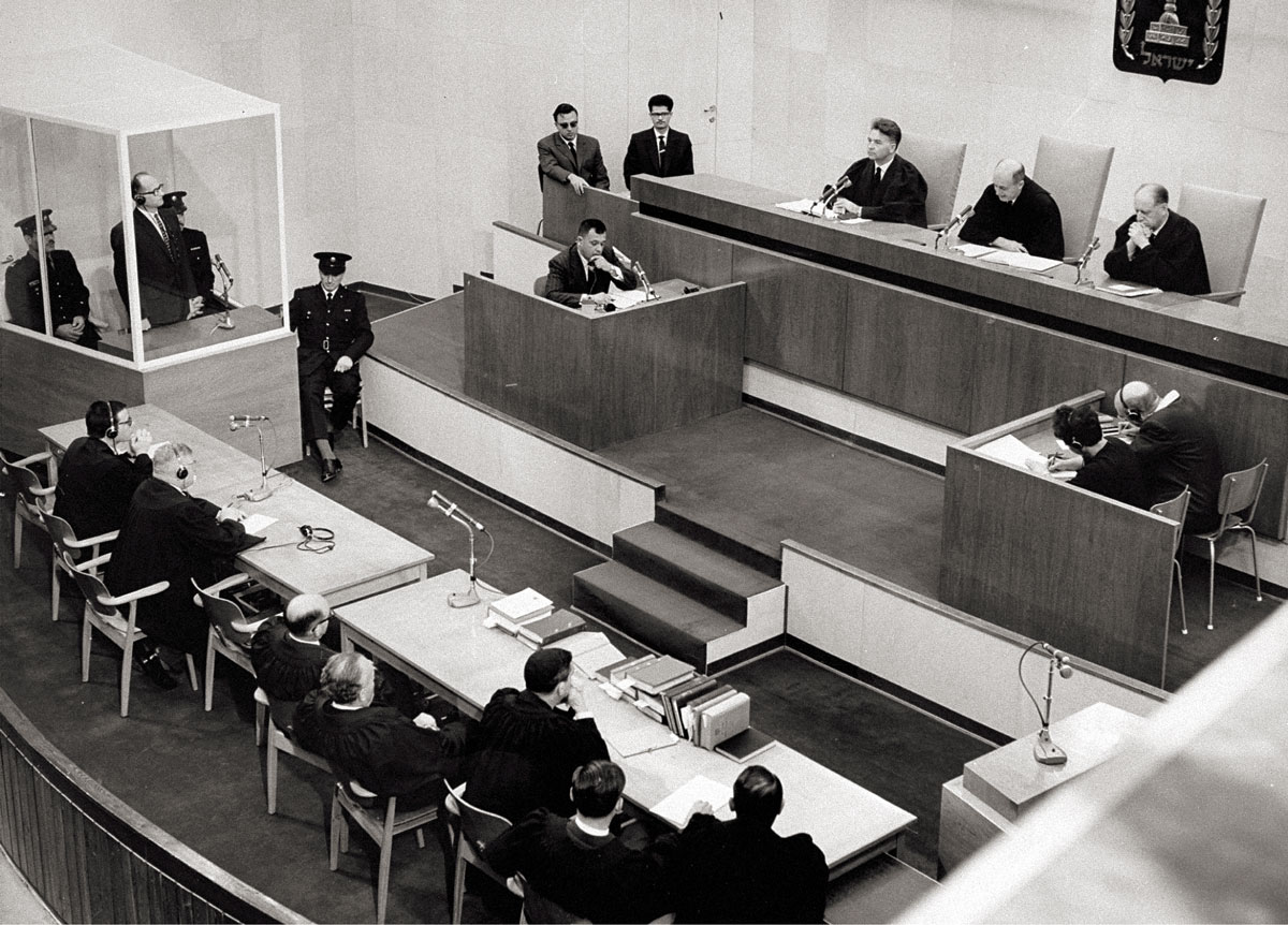 A photograph of Eichmann in his glass booth listening to his death sentence.