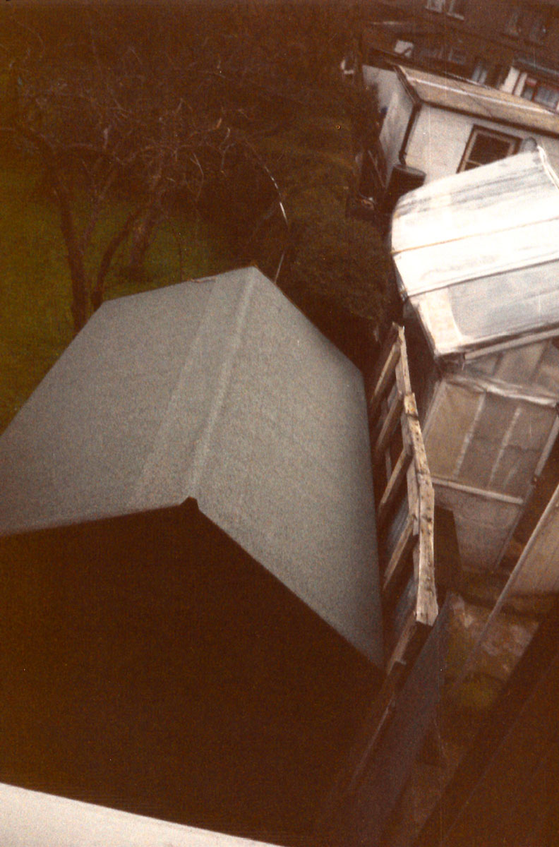 A photograph by Vera Merriman of her garden shed abutting the fence that delineates her property.