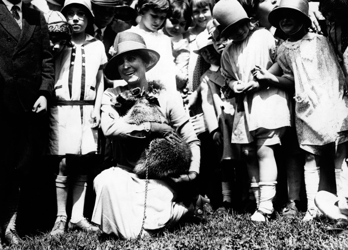 An undated image of the Taft family with their dog on a lawn.